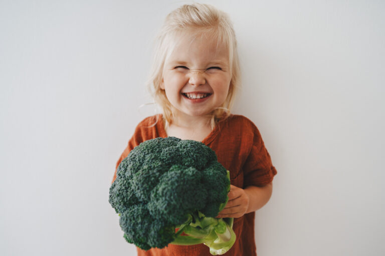 Image Child girl with broccoli healthy food vegan eating lifestyle organic vegetables plant based diet nutrition funny kid happy smiling